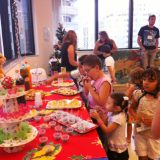 Imagem das crianças "atacando" a mesa de doces e lanches
